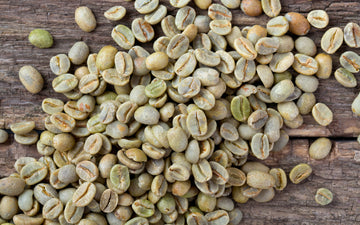 Green coffee beans on wooden table