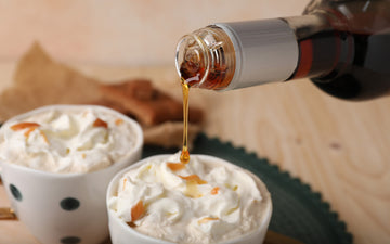 Pouring coffee syrup onto whipped cream topping