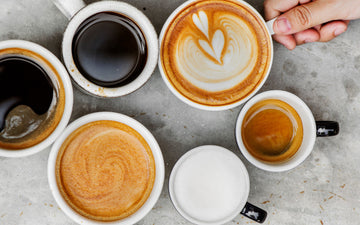 Several cups of coffee on a table